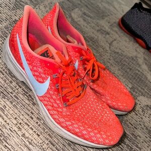 Bright orange Pegasus running shoes